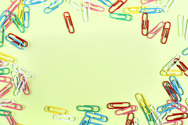 Multi-coloridas belas clipes de papel de papelaria nas bordas da superfície
 - Foto, Imagem