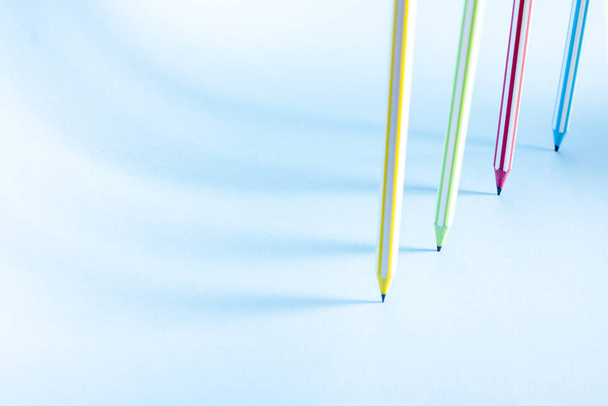 Four striped colored pencils stand upright - Φωτογραφία, εικόνα