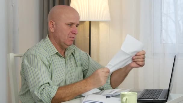 Businessman Make Accounting Calculation Read Invoices and Use Laptop Program - Felvétel, videó