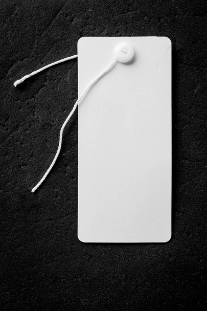 Blank price tag with copy space isolated on black background - Photo, Image