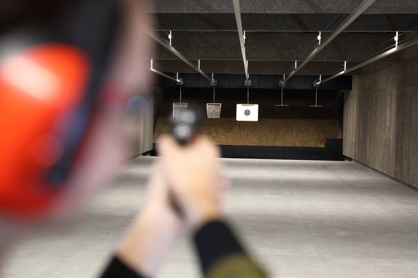Shooting the shield. Measuring to a paper target on the shooting range. - Fotó, kép