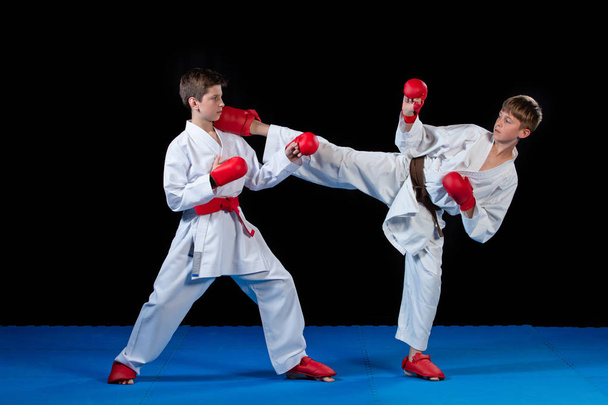 The studio shot of group of kids training karate martial arts - Foto, imagen