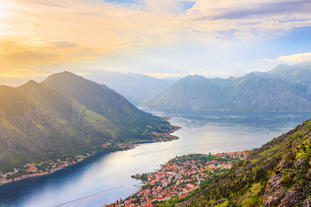Panoramic view from above on the old city Kotor, bay in Adriatic sea and mountains in Montenegro in the sunset time, gorgeous nature landscape. - Фото, зображення
