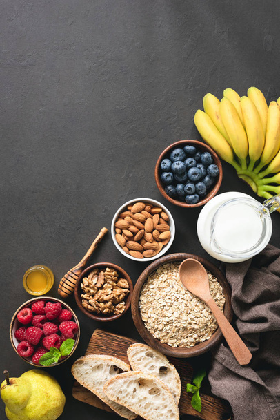 Healthy breakfast ingredients on black concrete background - Foto, immagini