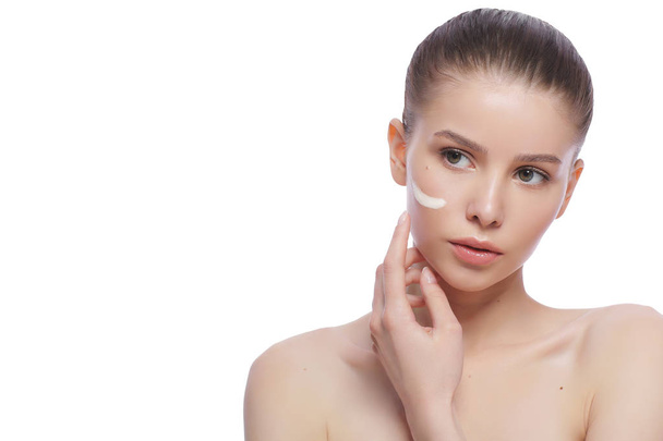 Portrait of a beautiful young woman, skin care with cream - Фото, изображение