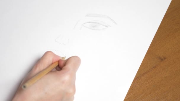 a female hand draws a portrait of a girl. 4k, close-up. Slow motion. view from above - Video