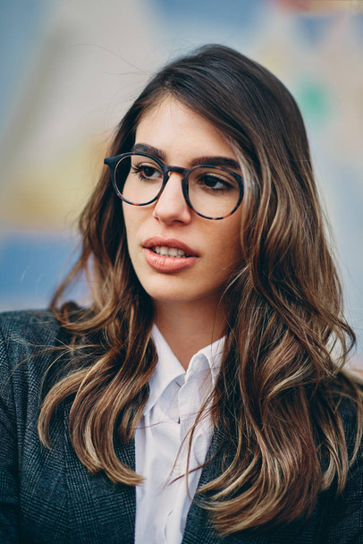 Head shot of beautiful brunette wearing glasses. - Фото, изображение