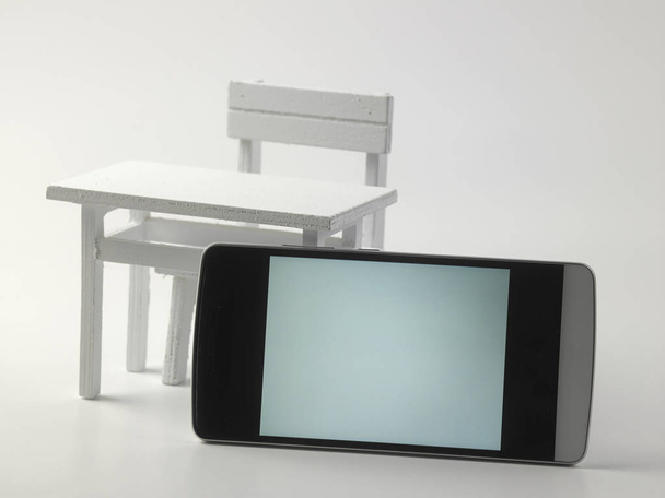 smartphone with blank screen on background miniature furniture - Photo, Image