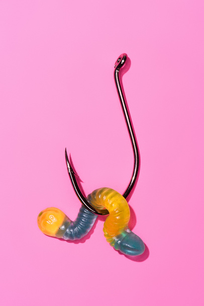 colorful gummy worm on fishing hook on pink - Photo, Image