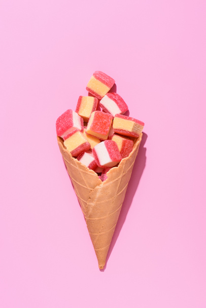 top view of delicious gummy candies in waffle cone on pink - Photo, Image