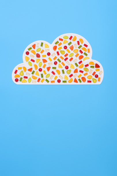 top view of cloud made of gummy candies isolated on blue - Photo, Image