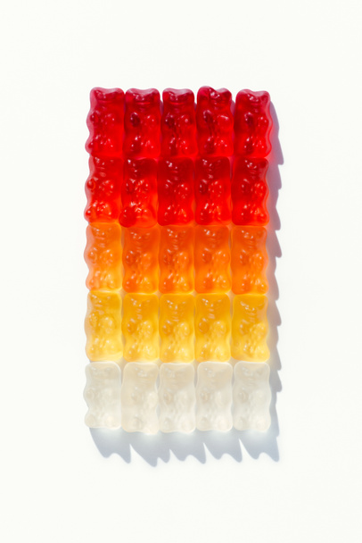 top view of composition of gummy bears in shape of gradient rectangle on white - Photo, Image