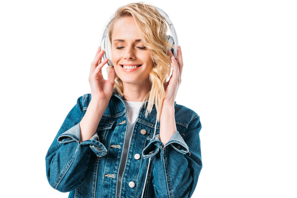 beautiful woman with closed eyes listening to music with headphones isolated on white - Valokuva, kuva