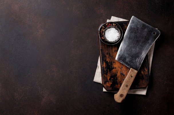 Butcher. Vintage meat knife and spices over stone board. Top view with space for your text - Fotografie, Obrázek