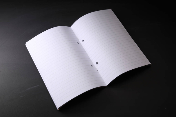 open blank exercise book on the blackboard - Fotoğraf, Görsel