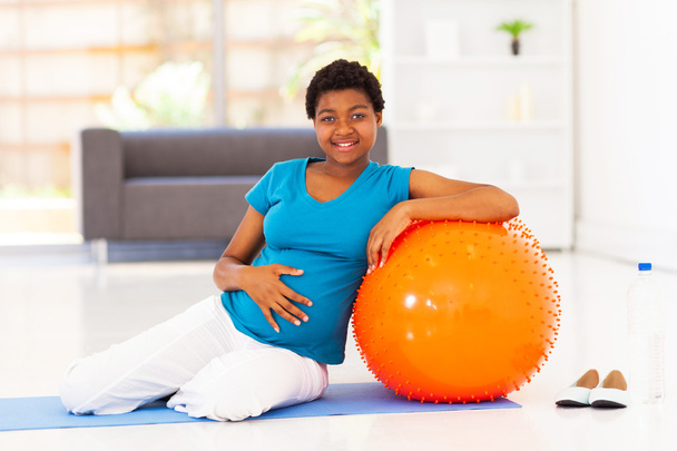 pregnant african american woman with exercise ball at home - Фото, изображение