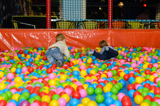 Active happy boys playing in the balls pool - Фото, зображення
