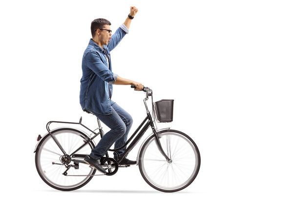 Young man riding a bicycle and gesturing happiness isolated on white background - Zdjęcie, obraz