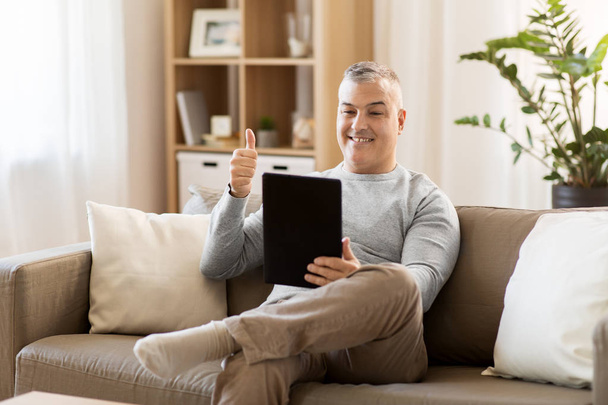 man having video chat on tablet pc at home - Photo, Image