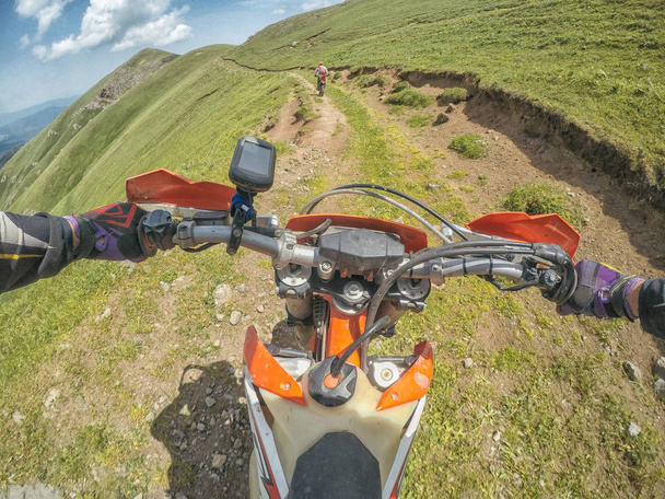 Extreme Adventure traveller with the dirt bike Enduro in high Caucasus mountains - 写真・画像