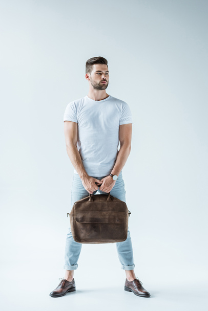 Handsome bearded man carrying briefcase on white background - Zdjęcie, obraz