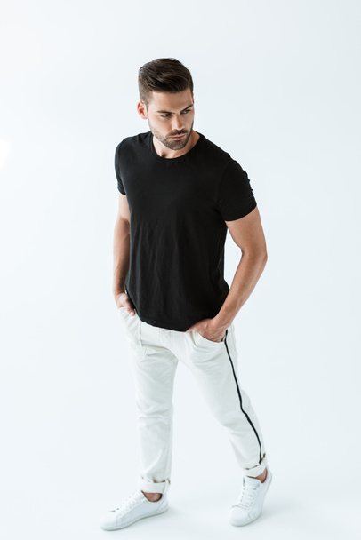 Stylish young man in black t-shirt posing on white background - Fotoğraf, Görsel