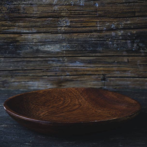 Close-up of new handmade empty dark wooden bowl on wooden rustic - 写真・画像