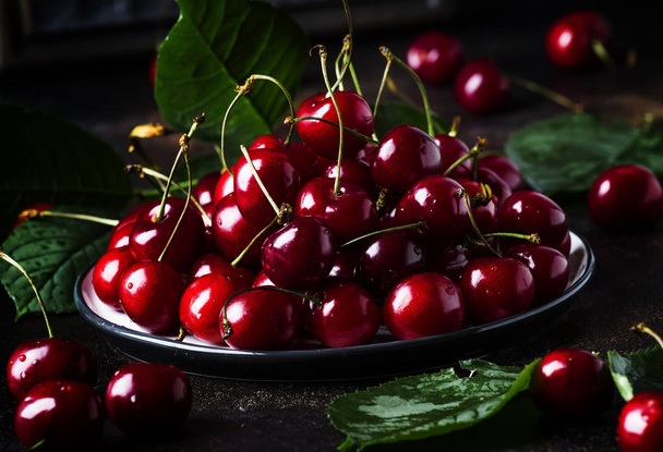 Red sweet cherries on brown table, selective focus - Photo, Image