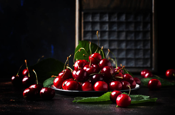 Red sweet cherries on brown table, selective focus - Fotoğraf, Görsel