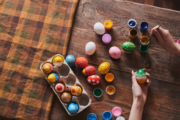 female hands painting egg for Easter holiday, close-up     - 写真・画像