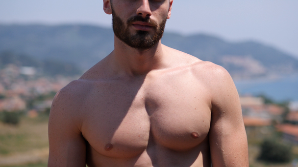 Vertical pan of shirtless athletic man - Filmati, video