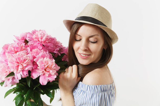 Close up young tender woman in blue dress, hat holding bouquet of pink peonies flowers isolated on white background. St. Valentine's Day, International Women's Day holiday concept. Advertising area - Foto, afbeelding