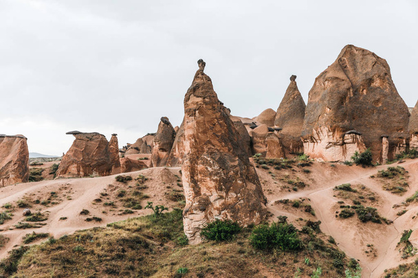 scenic landscape with eroded bizarre rock formations in famous cappadocia, turkey    - Photo, Image