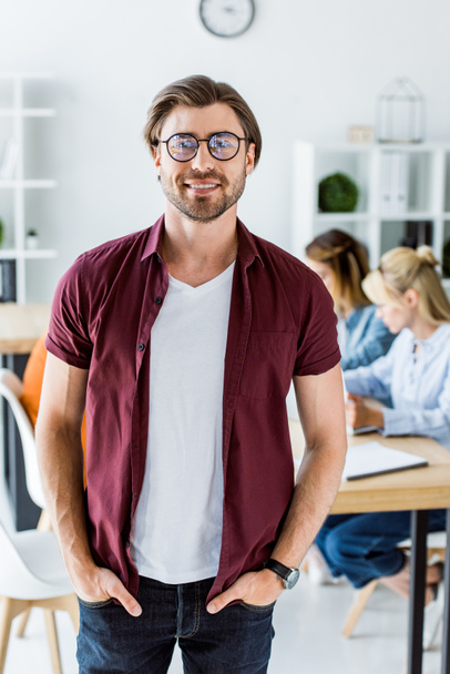 handsome man standing in office of startup project and looking at camera - Фото, зображення