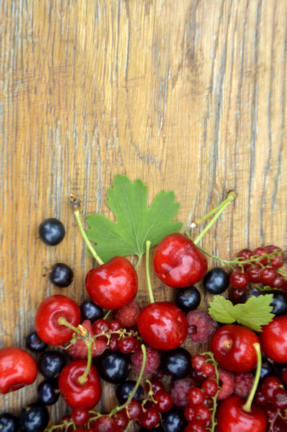 Fresh organic summer berries on wooden background. Copy space for text - Valokuva, kuva