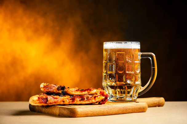 Slice of delicious homemade pizza served with light cold beer on - Valokuva, kuva