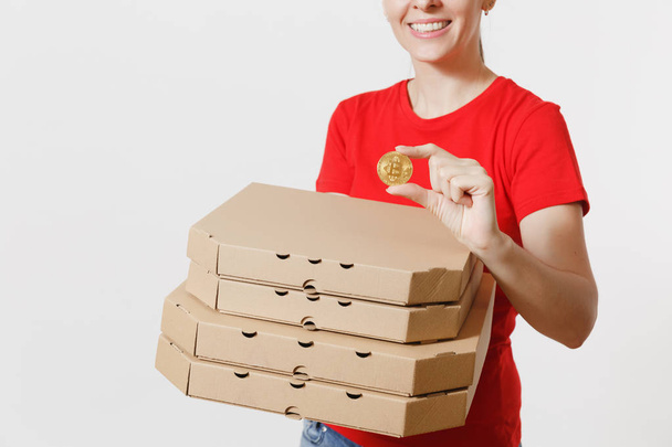 Delivery woman in red cap, t-shirt giving food order italian pizza in cardboard flatbox boxes isolated on white background. Female pizzaman working as courier holding bitcoin, coin of golden color - Photo, Image