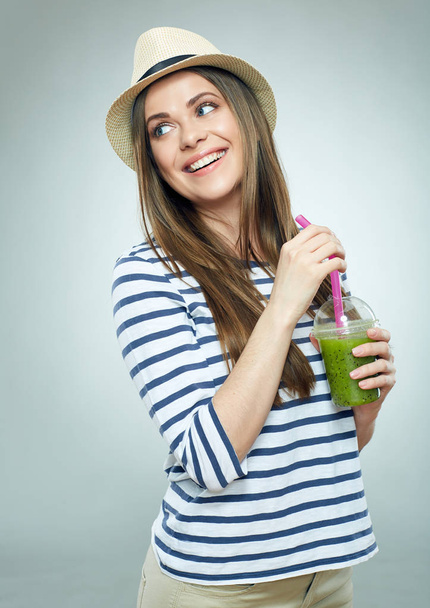 Happy woman in hat and striped shirt holding glass with green juice  - Φωτογραφία, εικόνα