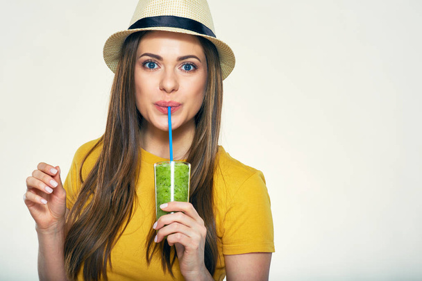portrait of young woman in hat drinking juice with straw  - Foto, imagen