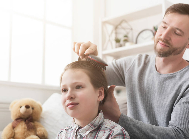 Handsome father combing daughter at home - Foto, Imagem