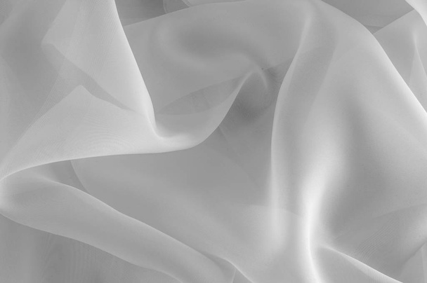 Texture, background, pattern. Silk fabric is transparent, white in color. Abstract soft chiffon texture background. Soft white chiffon with curve and wave - Photo, Image