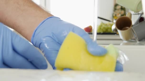 スポンジ手袋ウェットを着ている男の手を閉じるし、キッチンの掃除 - 映像、動画