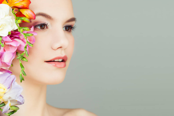 Beautiful Young Woman with Vivid Flowers. Spa Beauty, Aromatherapy and Skincare Concept - Fotografie, Obrázek