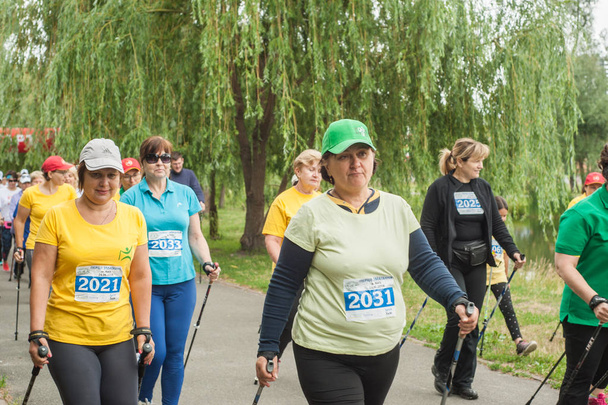 Kyiv, Ukraine - June 24, 2018: Participants of nordic walking Marathon in park. Senior women, age diversity - Foto, afbeelding