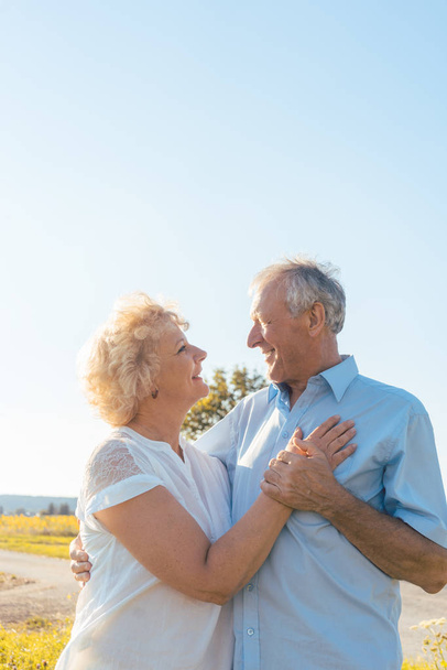 Романтическая пожилая пара, наслаждающаяся здоровьем и природой в солнечный день
 - Фото, изображение