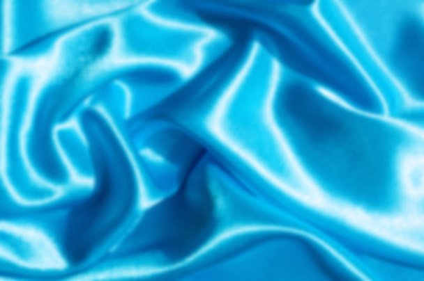 The blur is gaussian for designers. Texture, fabric, background. Abstract background of luxurious fabric or liquid waves or wavy grunge crease silk satin texture . Blue - Foto, Bild