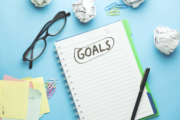 goals text on notebook  on blue background - Φωτογραφία, εικόνα