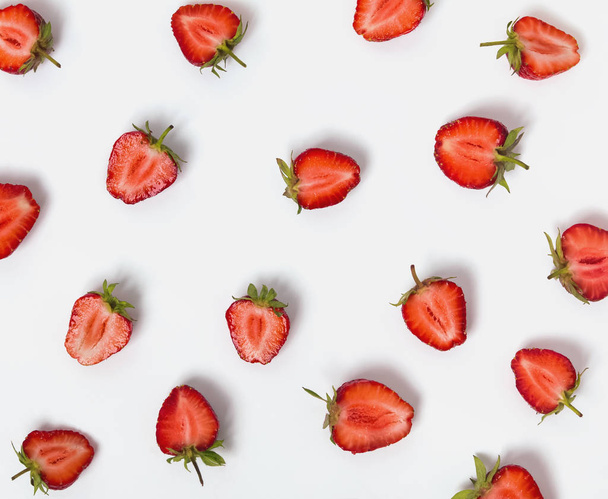 Halves of strawberries on the white background. - Фото, изображение