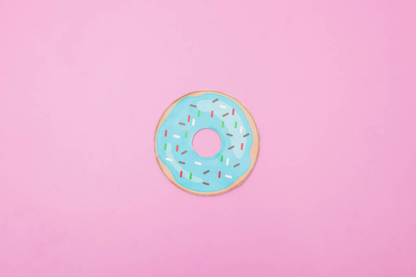 Photograph of an illustration of a donut on pink background - Valokuva, kuva