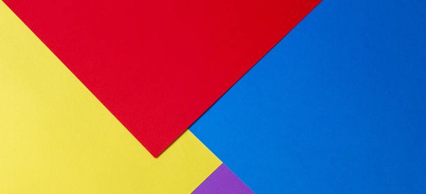 Colorful paper background with red, blue, violet and yelloe tones - Photo, Image